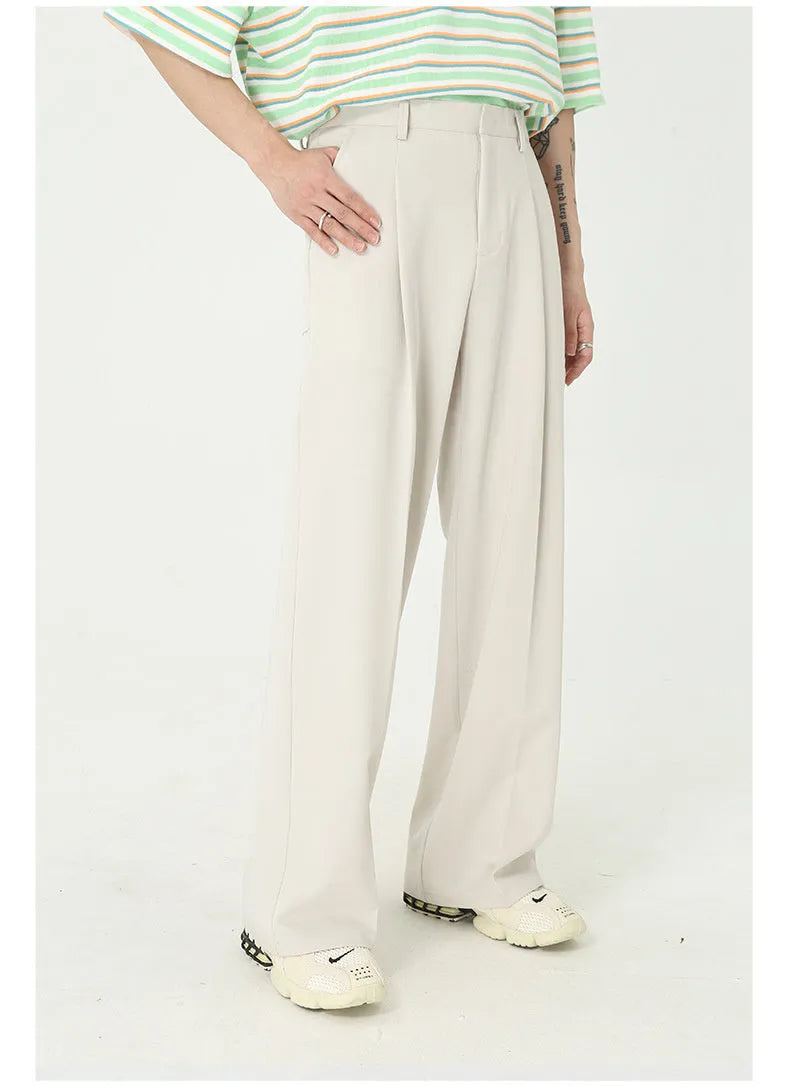Men's straight mid-waist suit pants in black polyester blend, lying flat, showing straight leg cut and mid-rise waistband.