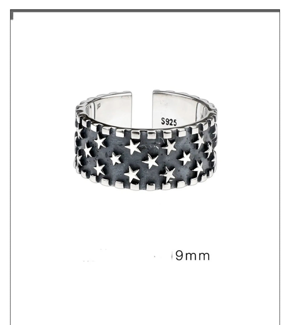 Sterling silver ring with a five-pointed star pattern and an adjustable open band.