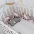 Baby cot bumper braid in spandex crystal velvet, shown in a light grey colour, wrapped around white crib rails.
