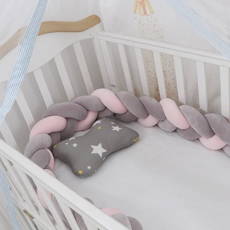 Baby cot bumper braid in spandex crystal velvet, shown in a light grey colour, wrapped around white crib rails.