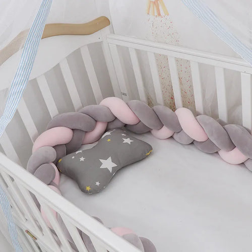 Baby cot bumper braid in spandex crystal velvet, shown in a light grey colour, wrapped around white crib rails.
