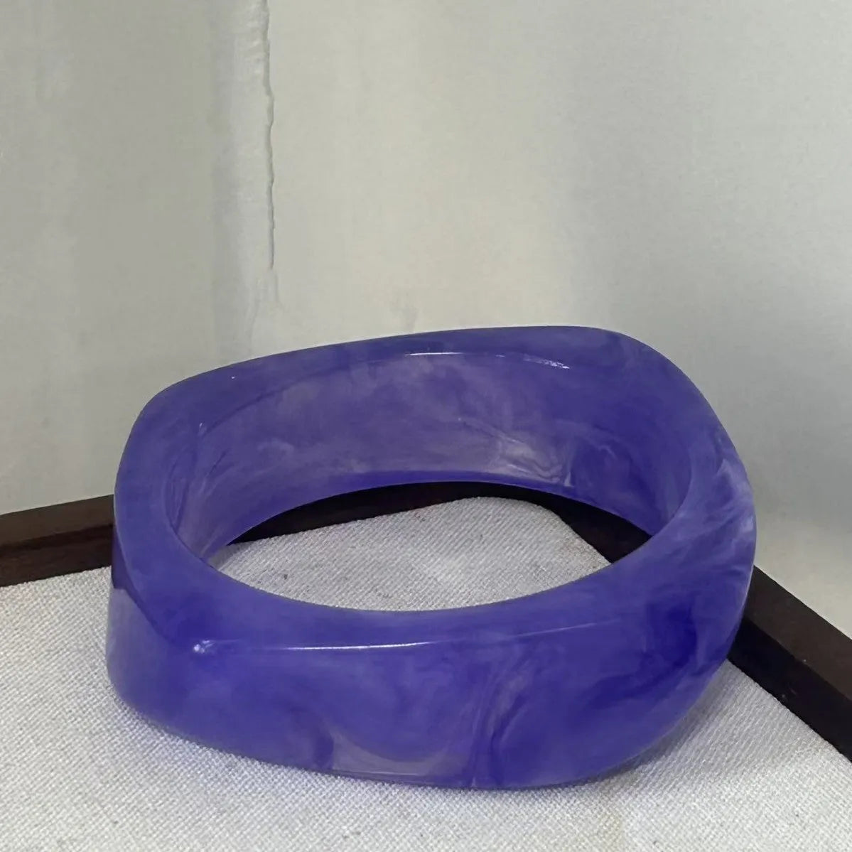 Geometric blooming resin curved bracelet in diamond transparent purple with polished finish