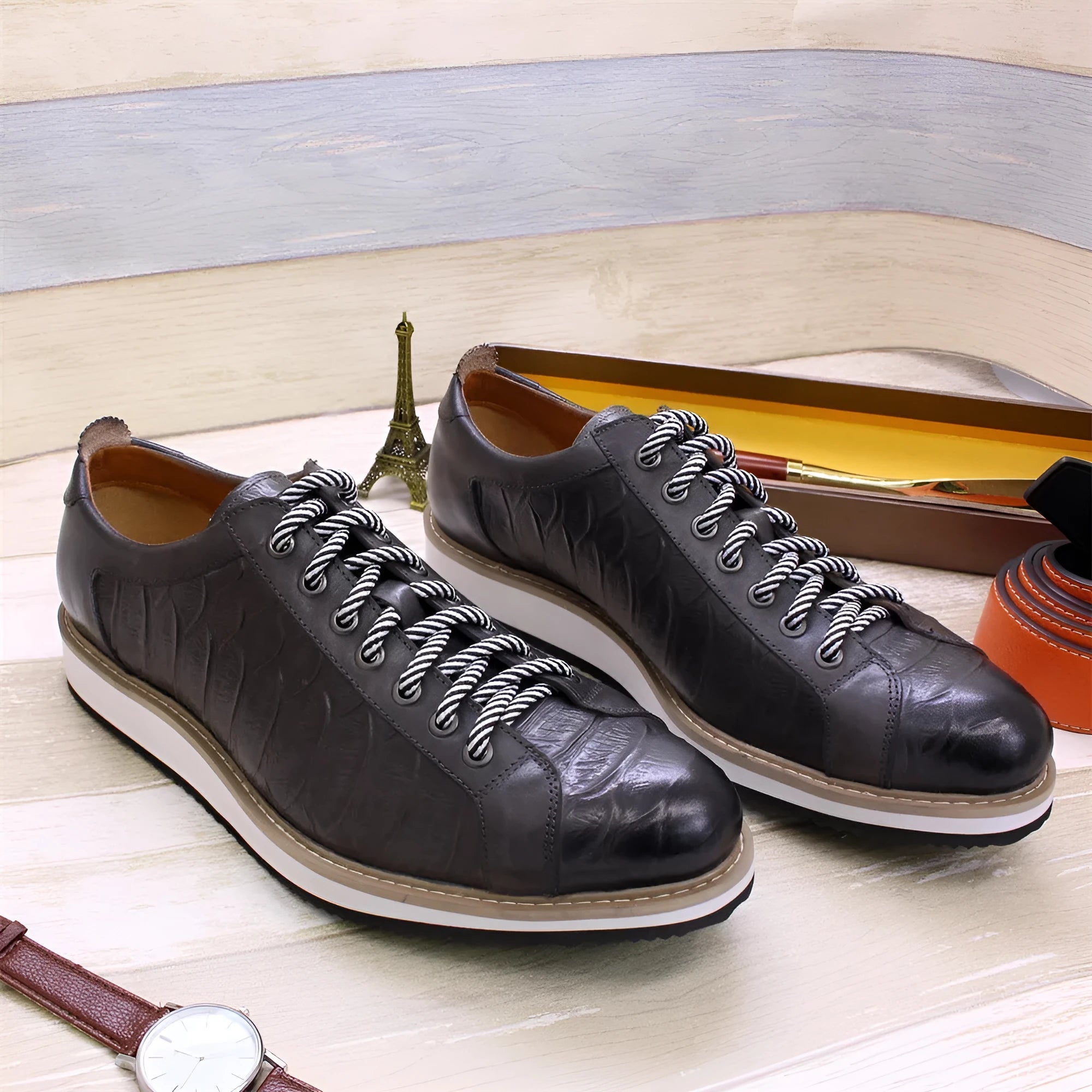 Handmade men's low-cut shoes with an embossed pattern and front-tie lacing.