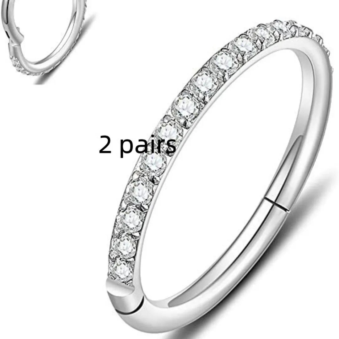Close-up of a round, seamless stainless steel nose ring in a gold finish, showing its smooth, clasp-free design.