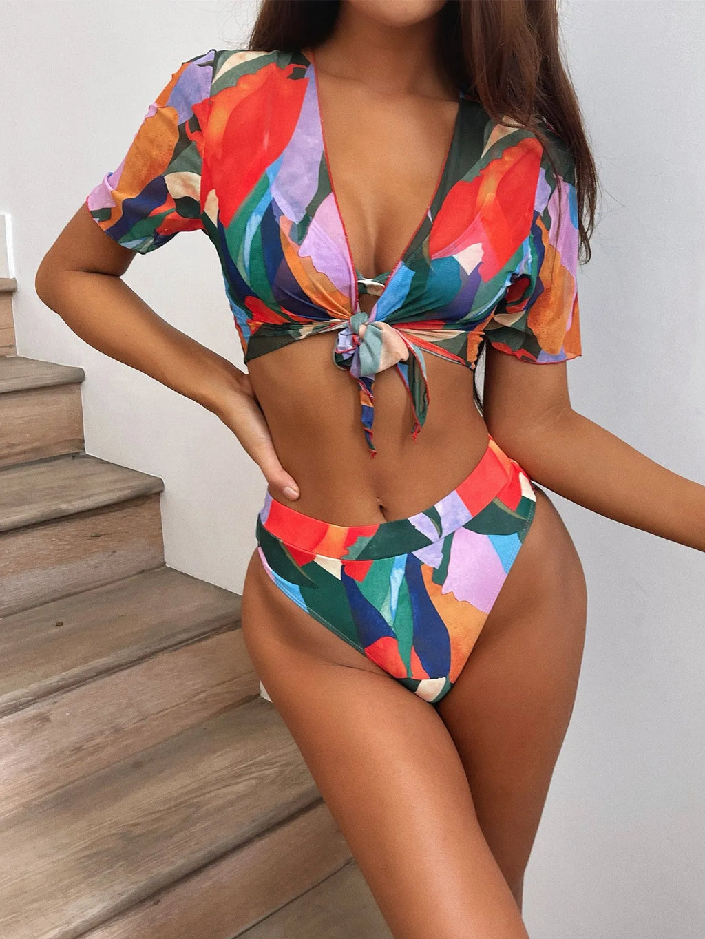 Red women's split bikini swimsuit made from nylon fabric.
