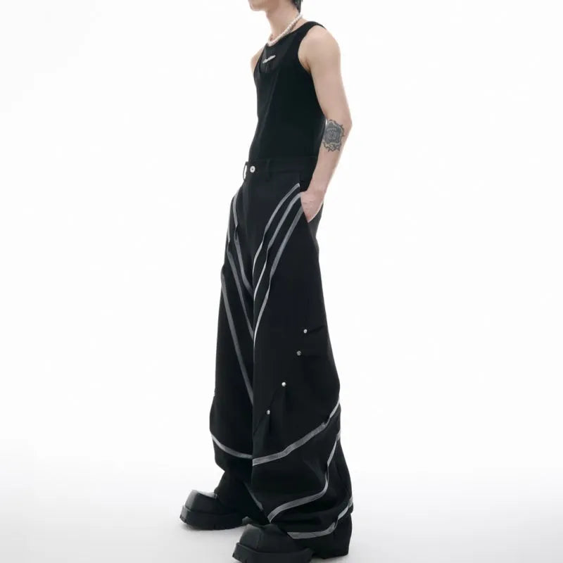 Men's polyester trousers with pleats and metal rivet detailing, shown in black and white colour options.