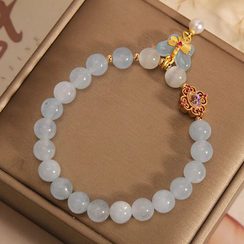Women's crystal bracelet with aquamarine butterfly pendant and rhinestone decoration