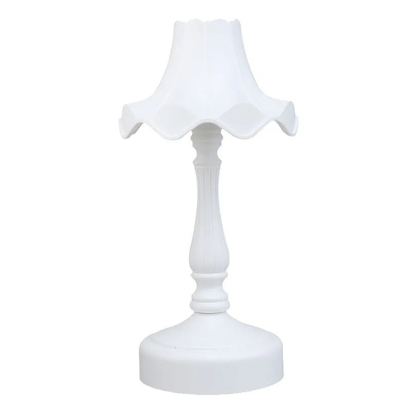 Cute cream retro table lamp with pink floral accents on a desk