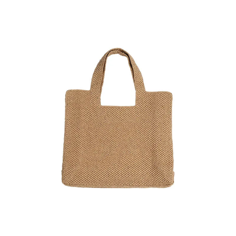 Straw woven bucket tote bag in beige colour showing woven texture and open top design