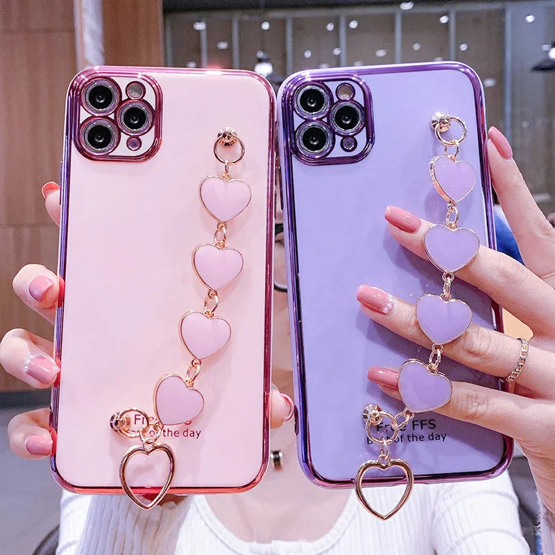 Silicone phone case with wrist bracelet for Samsung smartphones in solid green, pink, purple, or light green.