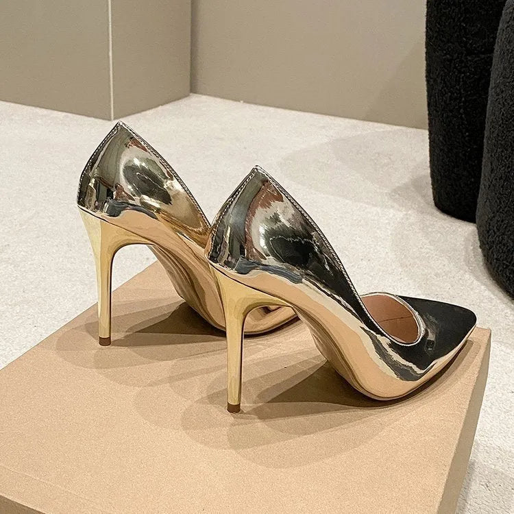 Women's gold metallic pointed toe stiletto heel slip-on pumps on a white background