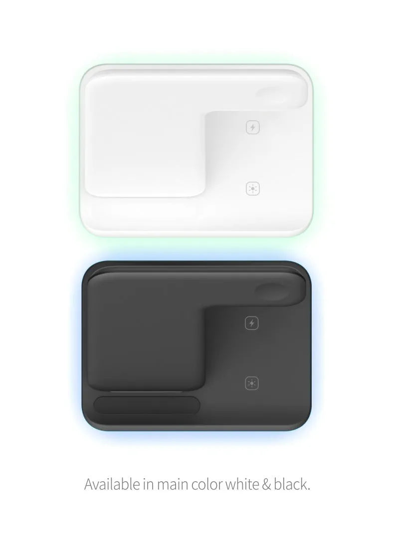 White three-in-one wireless charging stand holding a mobile phone, a smartwatch, and wireless earbuds on a desk.