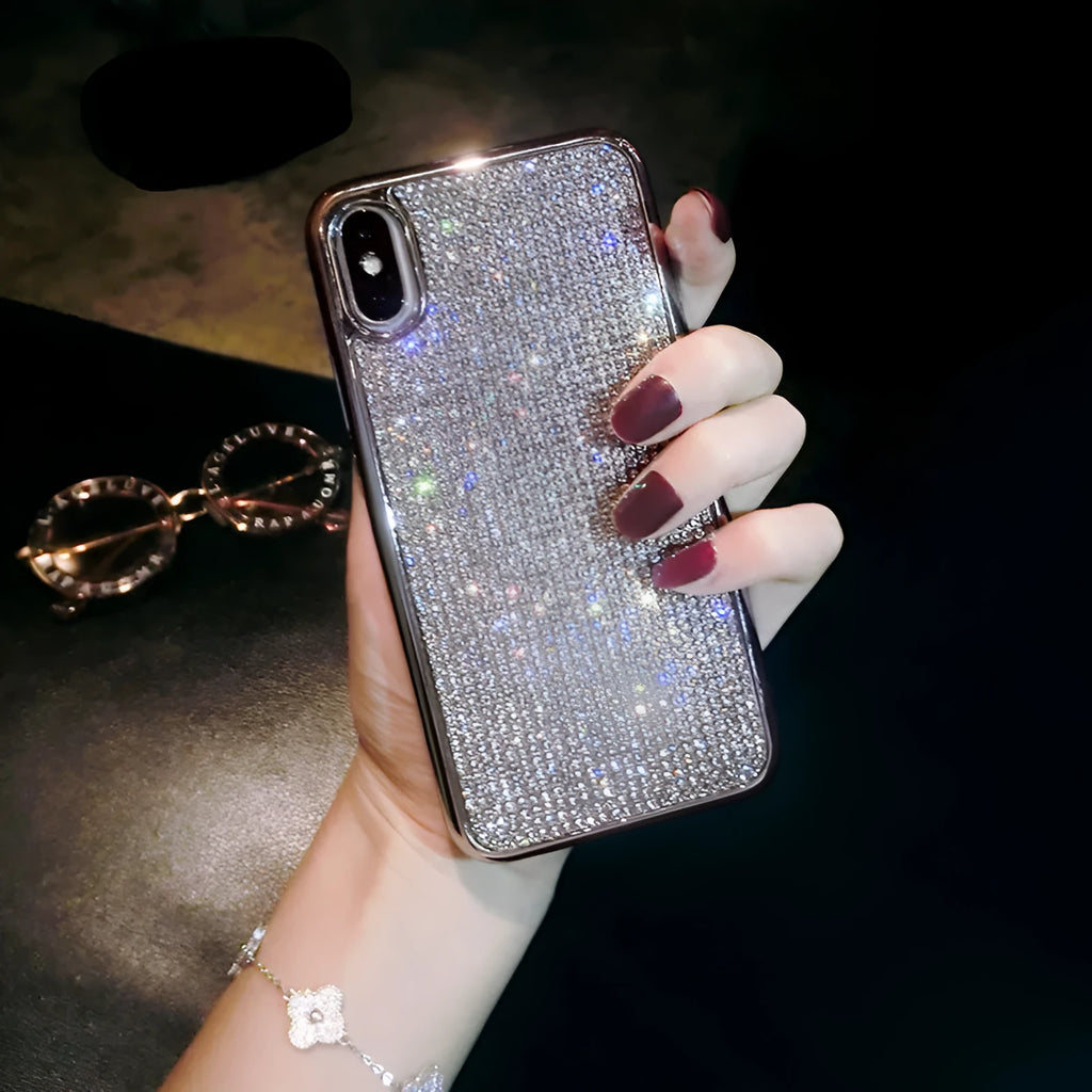 Silver silicone full diamond protective case for iPhone on a table.