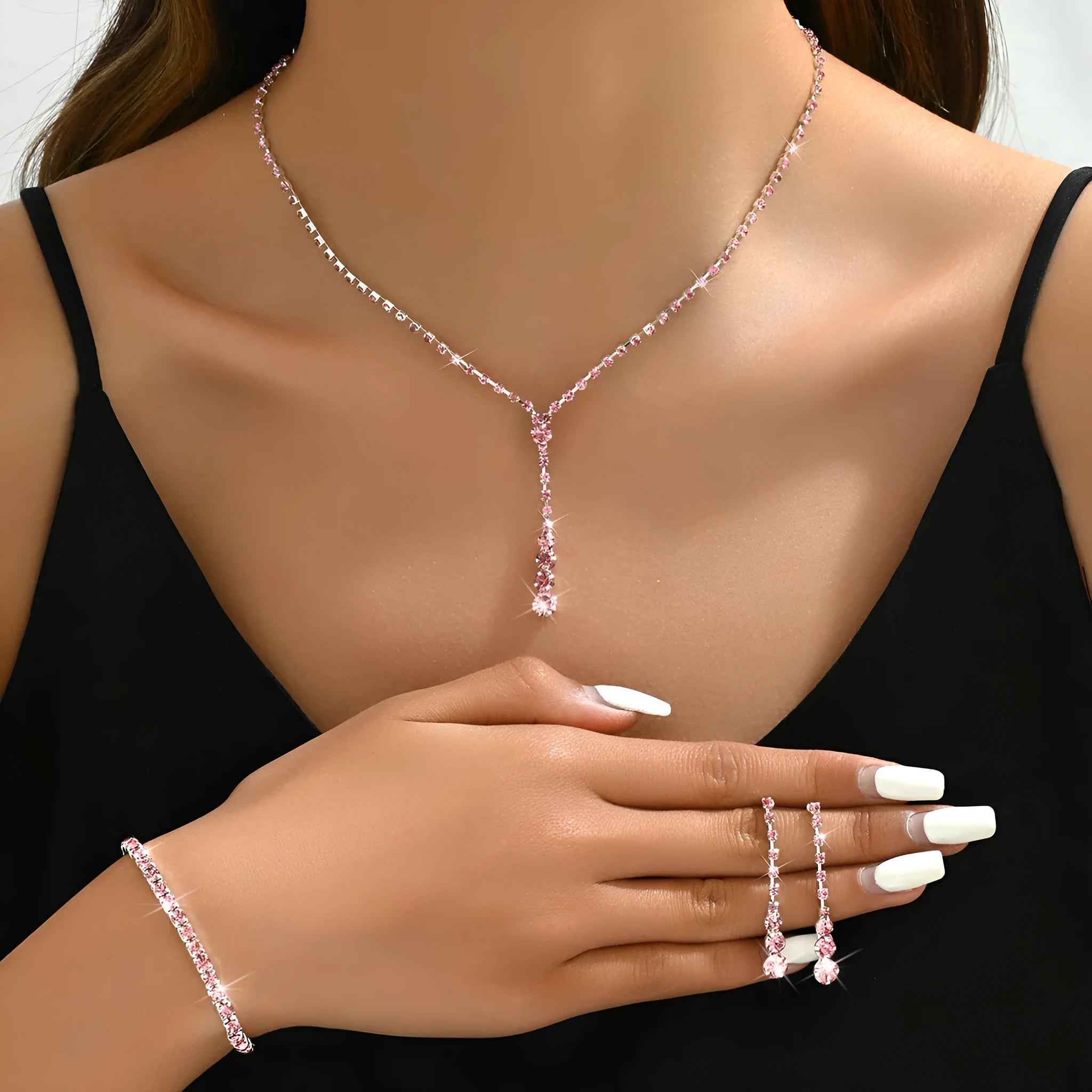 Wedding jewellery three-piece set showing necklace, bracelet and earrings with rhinestone pendants