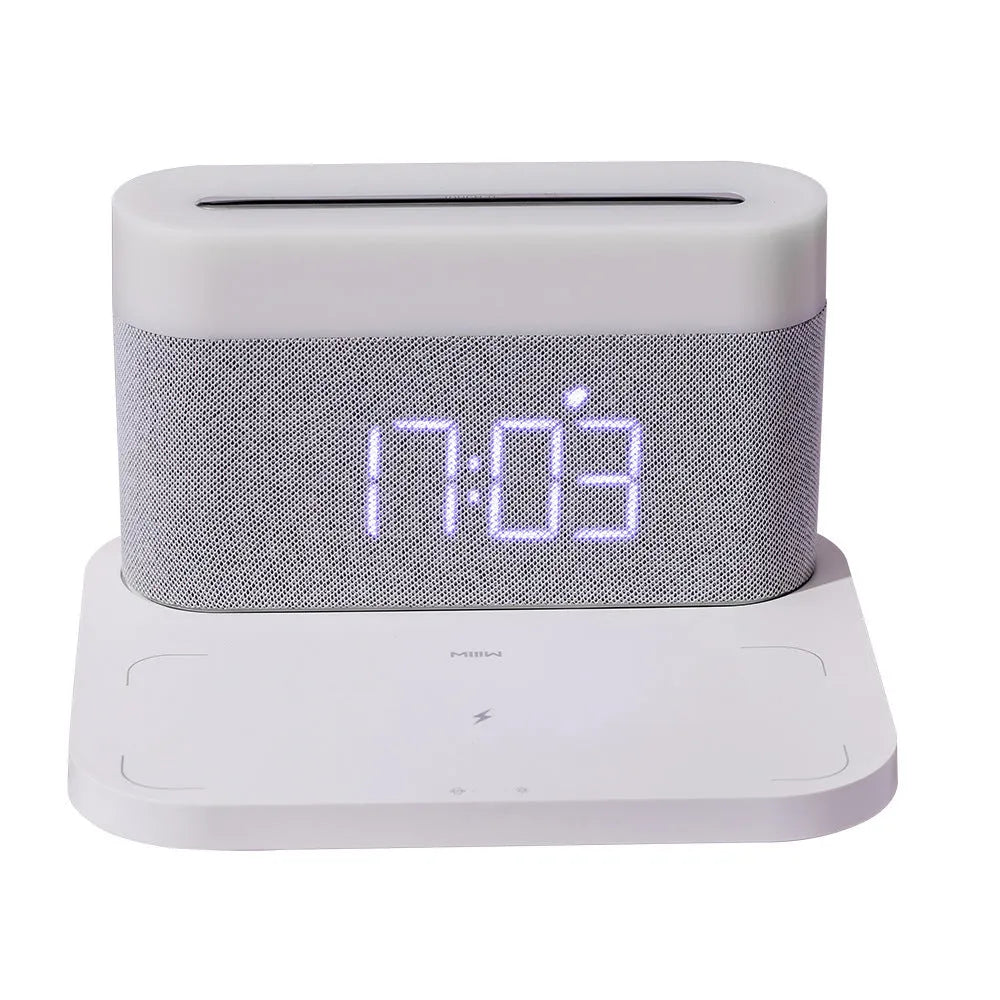 White bedside table lamp with integrated wireless phone charger and clock display