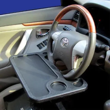 Multifunctional car desk in grey ABS with full suspension structure mounted on a car steering wheel, showing the adjustable angle handle