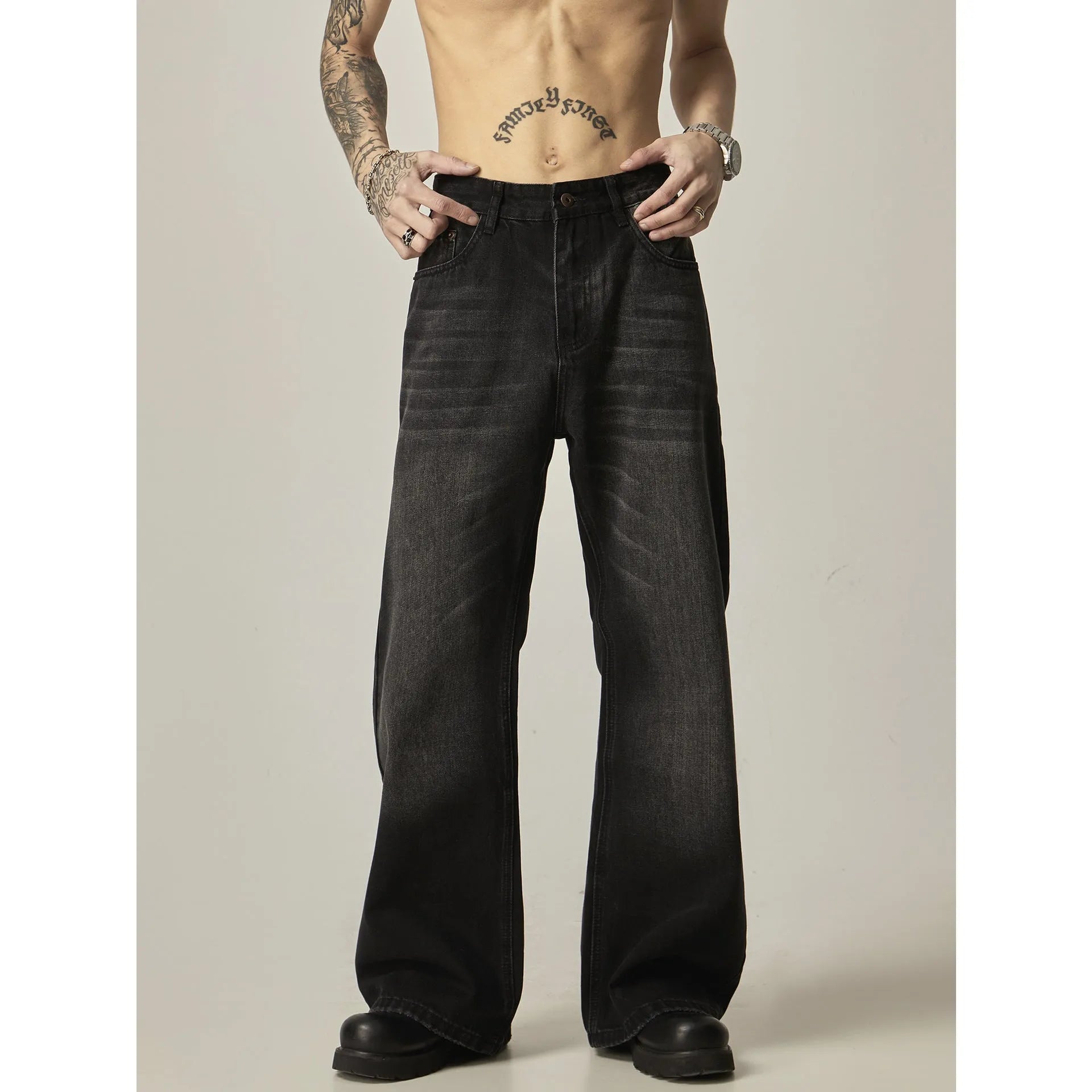 Black loose straight retro jeans with zipper fly closure on plain background