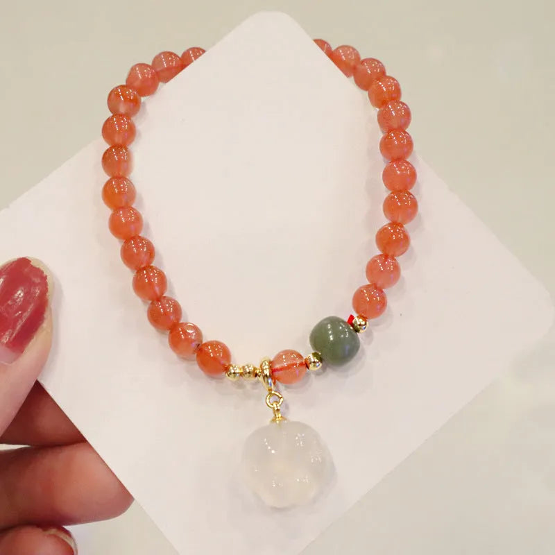 Natural red agate bracelet with jade inlay and a cat paw charm on a 6mm band.