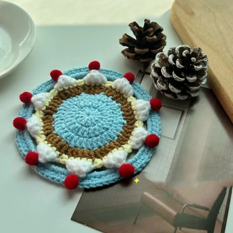 Round 9cm grey felted wool coaster next to its drawstring storage pouch.