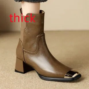 Brown cowhide leather women's Martin boots with a high heel and side zipper detail.