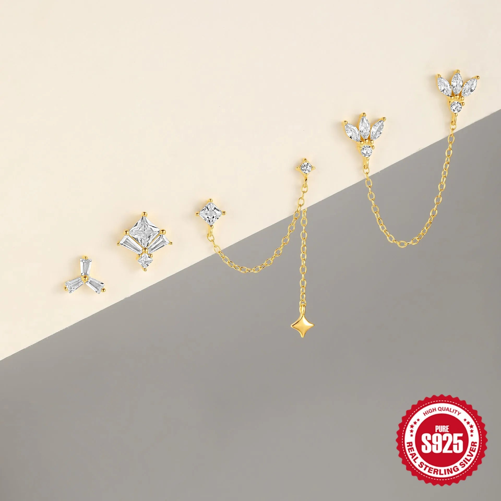 S925 sterling silver stud earring with golden double piercing design and zircon inlaid detail on a white background.
