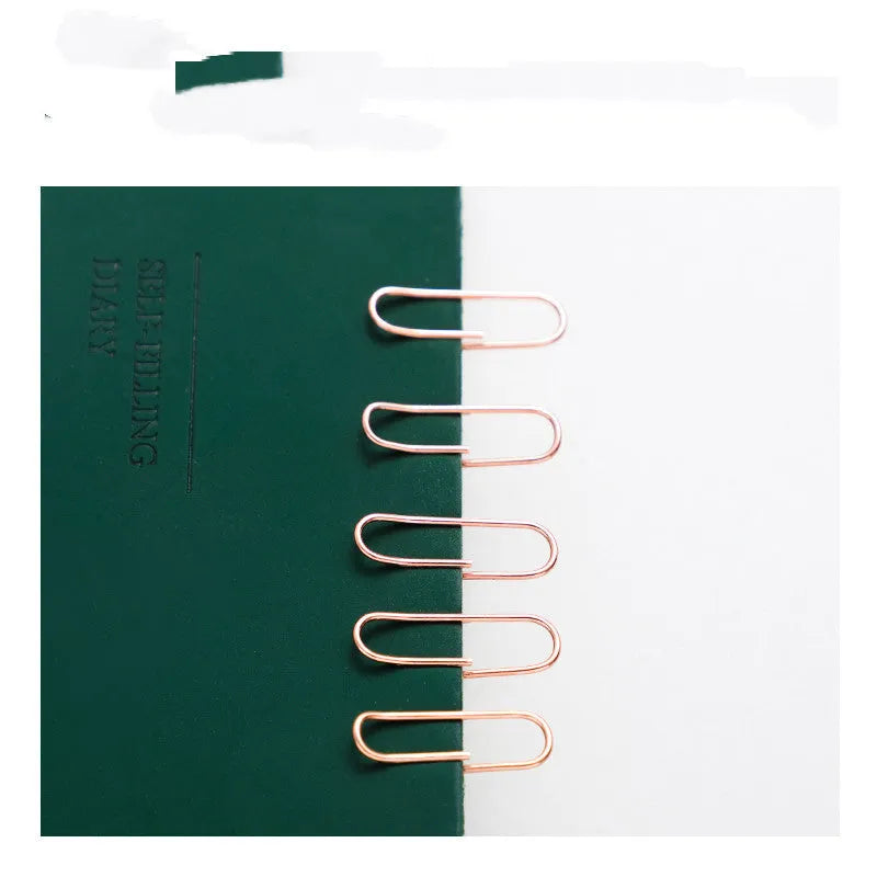 Rose gold coloured metal heart-shaped paper clips, size 28mm, in a box of 100 pieces.