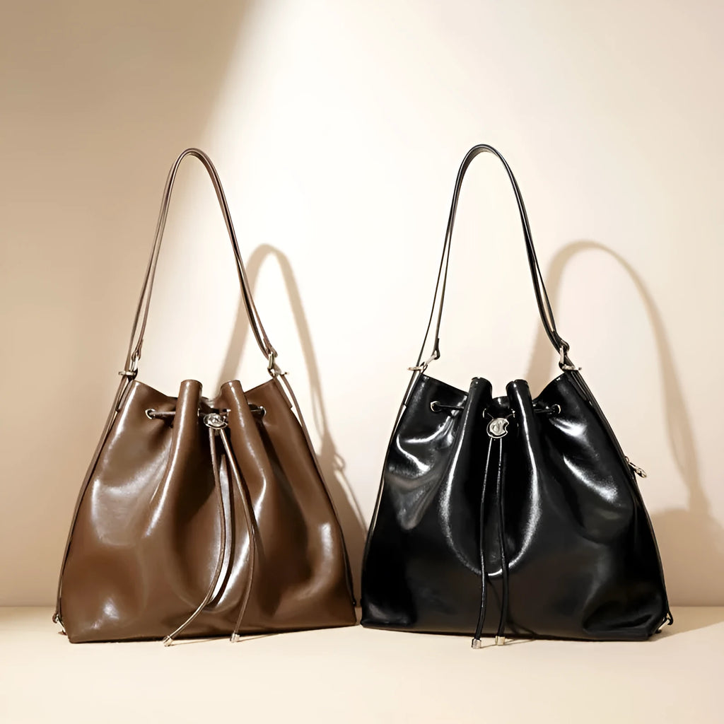 Genuine leather one shoulder bucket bag in brown showing retro style and interior pockets.