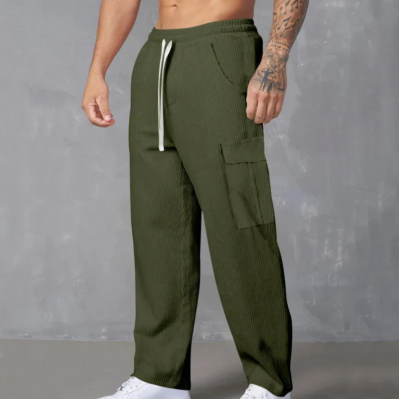 Men's loose-fitting corduroy cargo trousers in a straight-leg cut, shown in a solid colour.