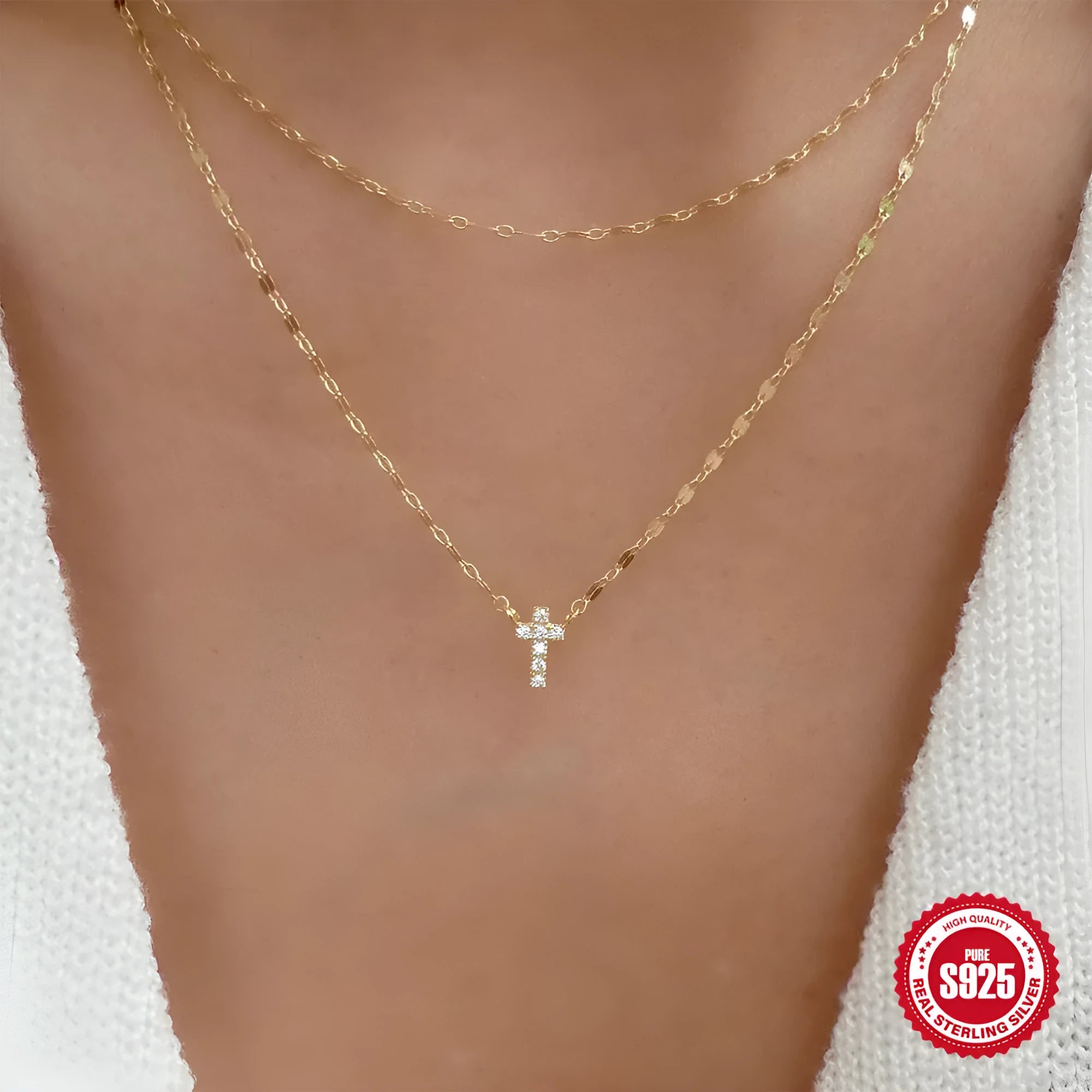 Sterling silver double layer cross pendant necklace with a clavicle chain in a gold tone finish.