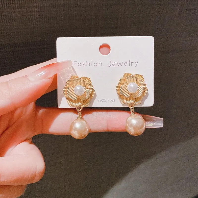 Gold-colour Hong Kong style floral stud earrings with opal stone and ice flower design on rose pearl motif.