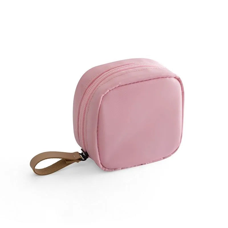 Cloth cube-shaped makeup storage bag with a plain pattern, shown in blue, pink, white, and white pink colour options