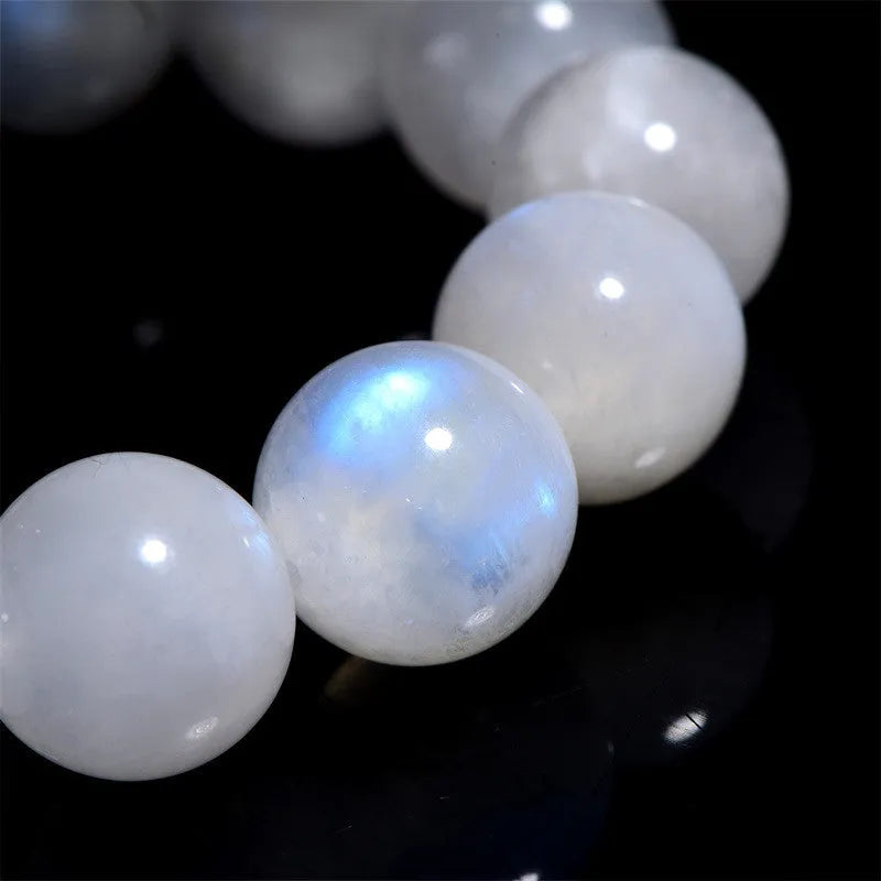 Natural blue moonlight coloured moonstone round bead bracelet on a white background.