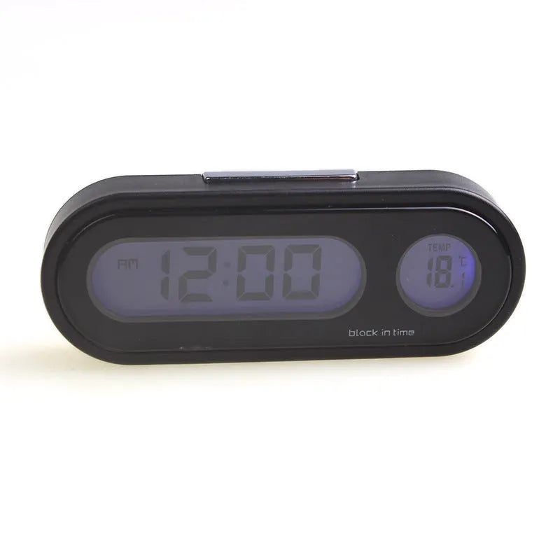 Black electronic car clock and thermometer with luminous digital display on an adjustable dashboard mount.