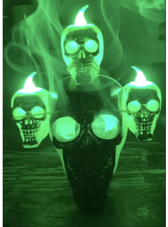 Halloween skull ornament with LED light, gold and silver, plastic, 14x12x9cm, on dark background