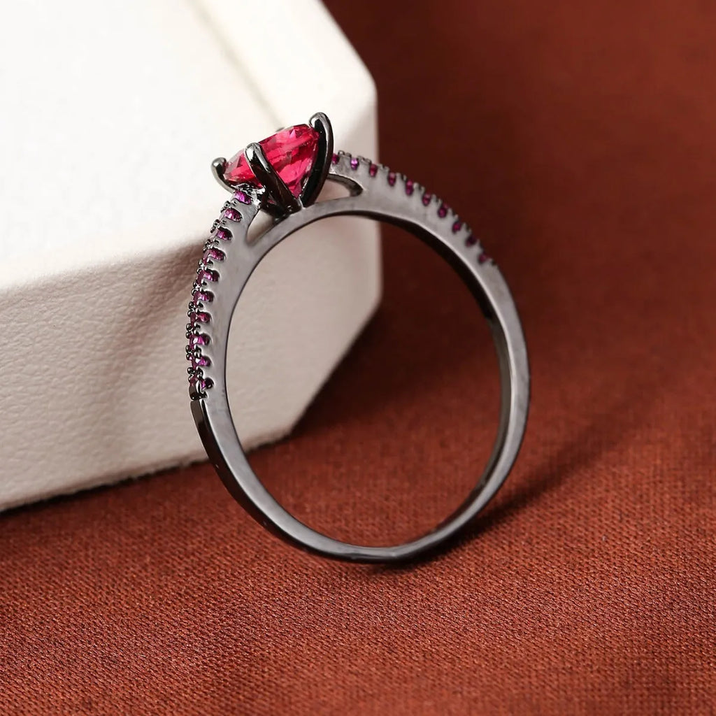 Geometric hexagon zircon ring in copper on a grey background, showing gold rose red and gun black purple colour options.