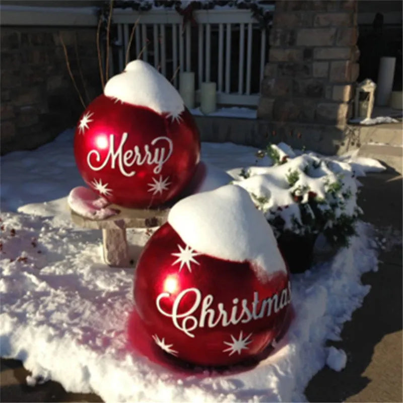 Large red and white striped inflatable Christmas ball ornament hanging on an outdoor tree