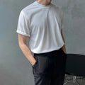 Slim fit men's cotton T-shirt in black on a white background, showing round neck and short sleeves.
