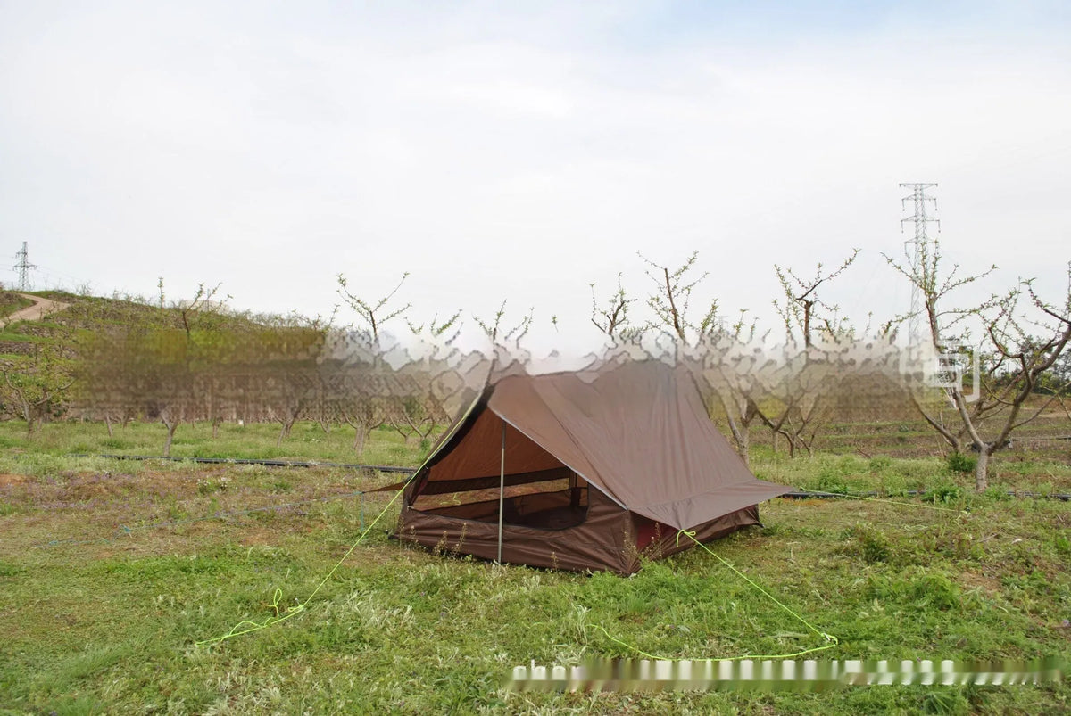 Brown A-line tent for 2-3 people with PU4000 waterproof fabric, 210x150x110cm, set in a grassy campsite.