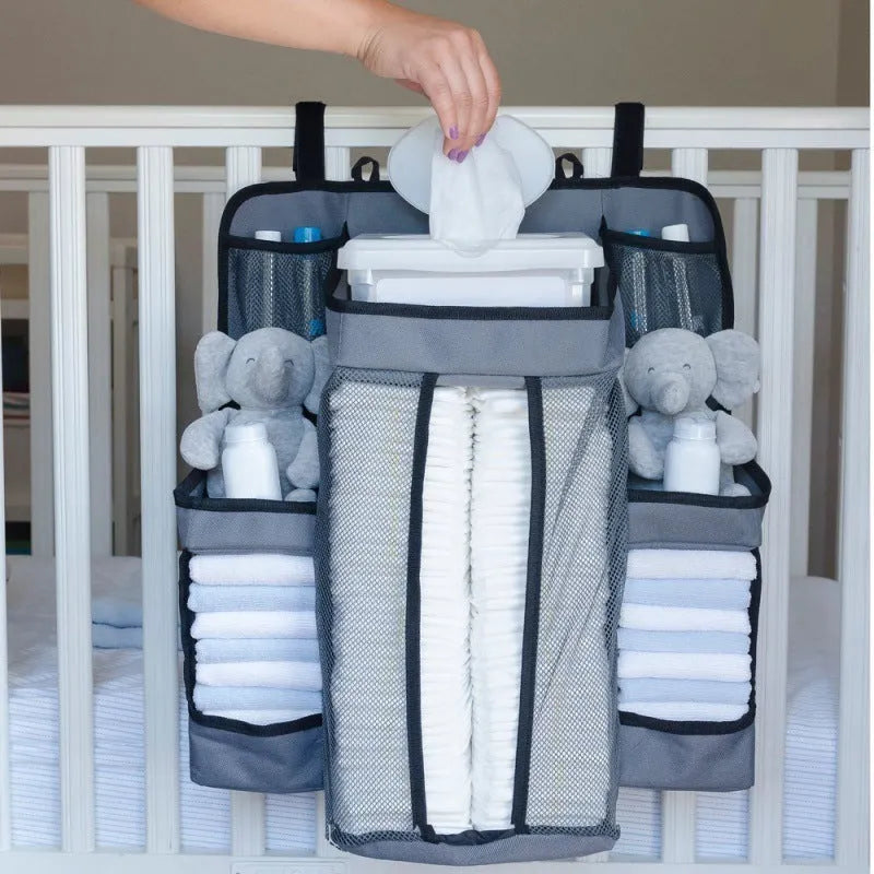 Gray baby diaper organizer hanging on crib with adjustable Velcro straps, TC Oxford cloth construction