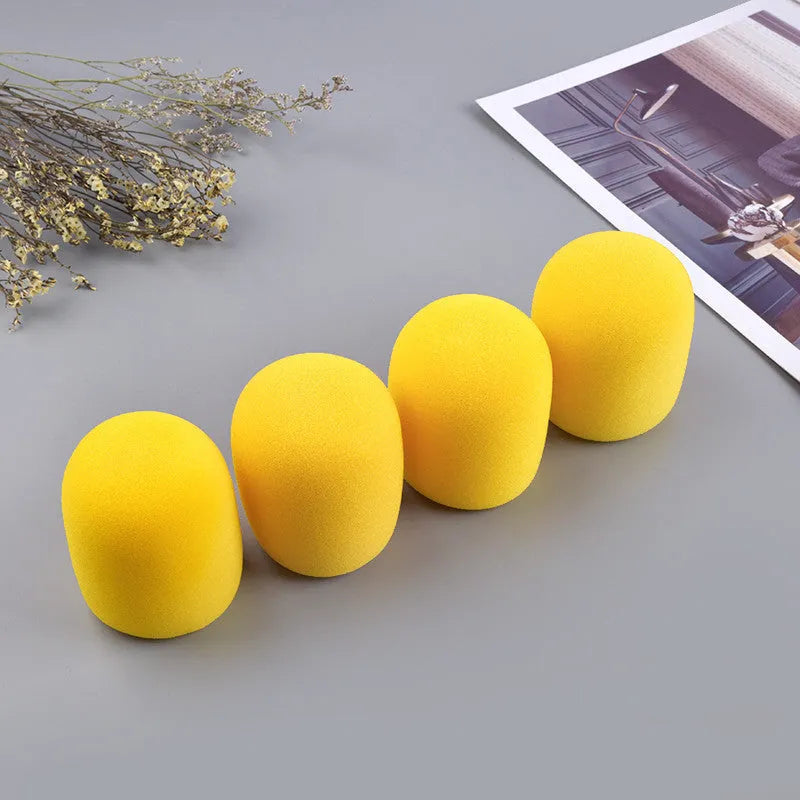 Four multicoloured foam microphone windshields for ball-shaped handheld stage microphones