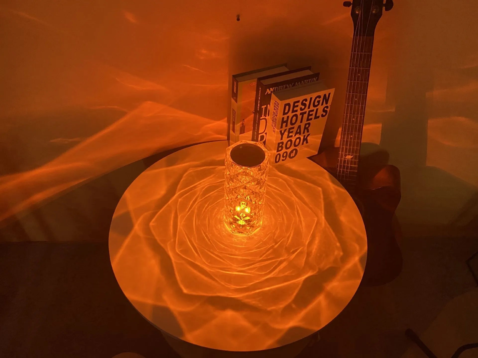 Modern acrylic rose LED table lamp with diamond base and touch control on wooden surface