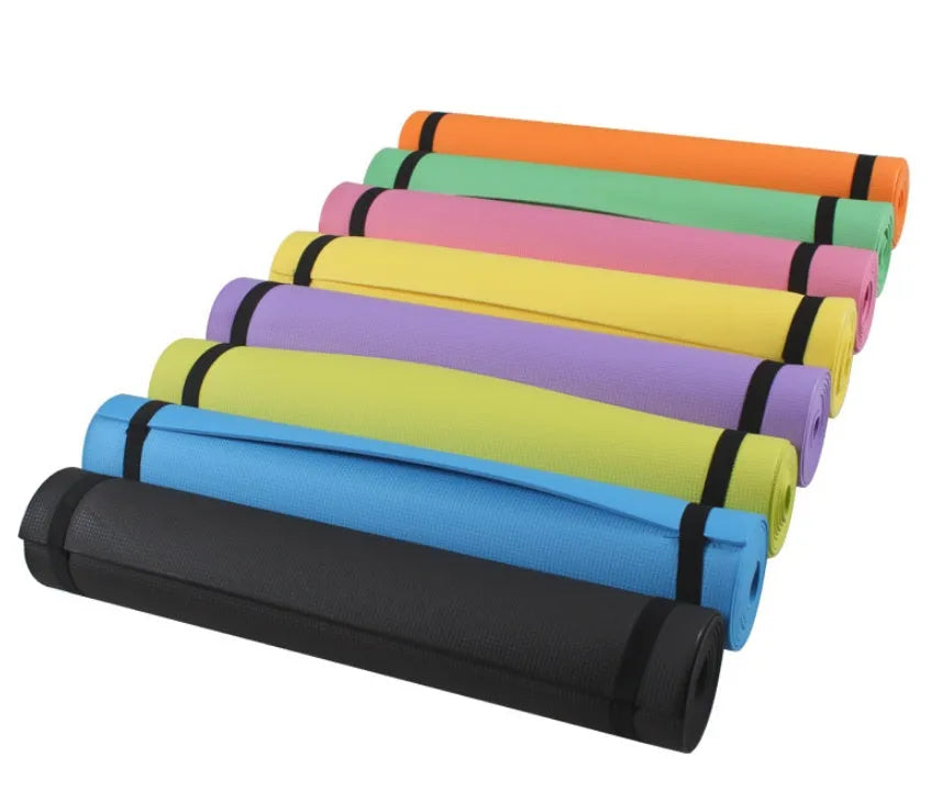 Red EVA fitness yoga mat with rolled edge showing thickness, laid flat on a wooden floor.