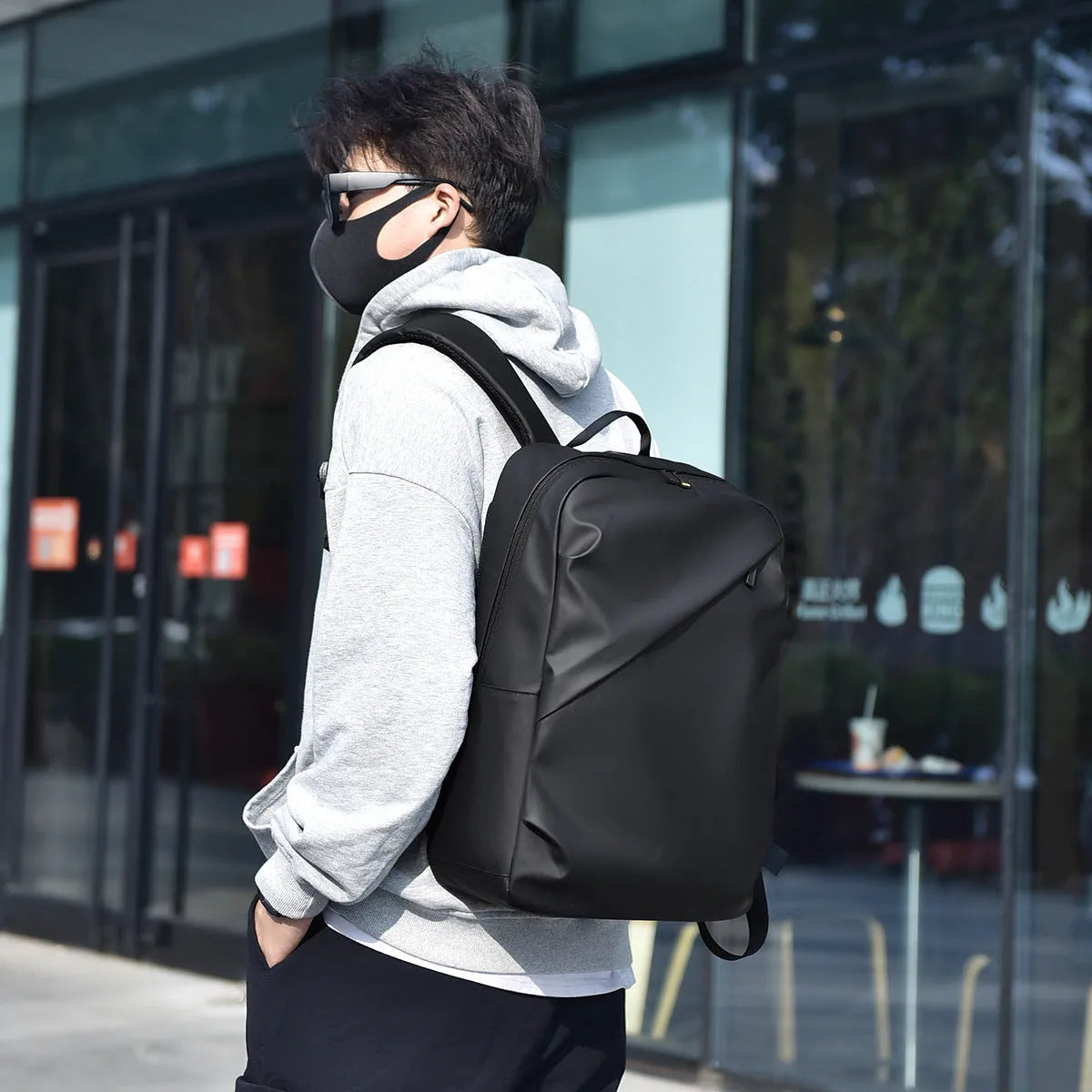 Men's waterproof backpack in black, blue or grey colour with PU leather construction and sewing thread detailing