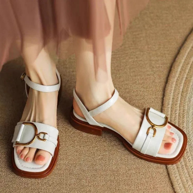 Women's casual leather sandals with thick rubber sole and button closure in black, beige, or brown.