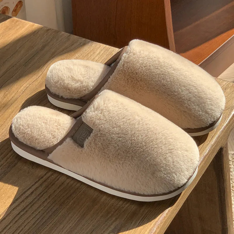 Solid colour winter plush slippers with non-slip PVC soles on a wooden floor
