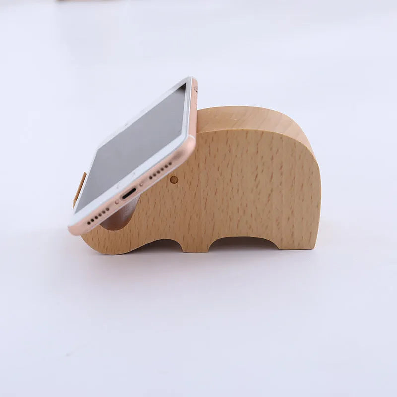 Beech wood and resin lazy bracket mobile phone holder in an animal design style on a desk.