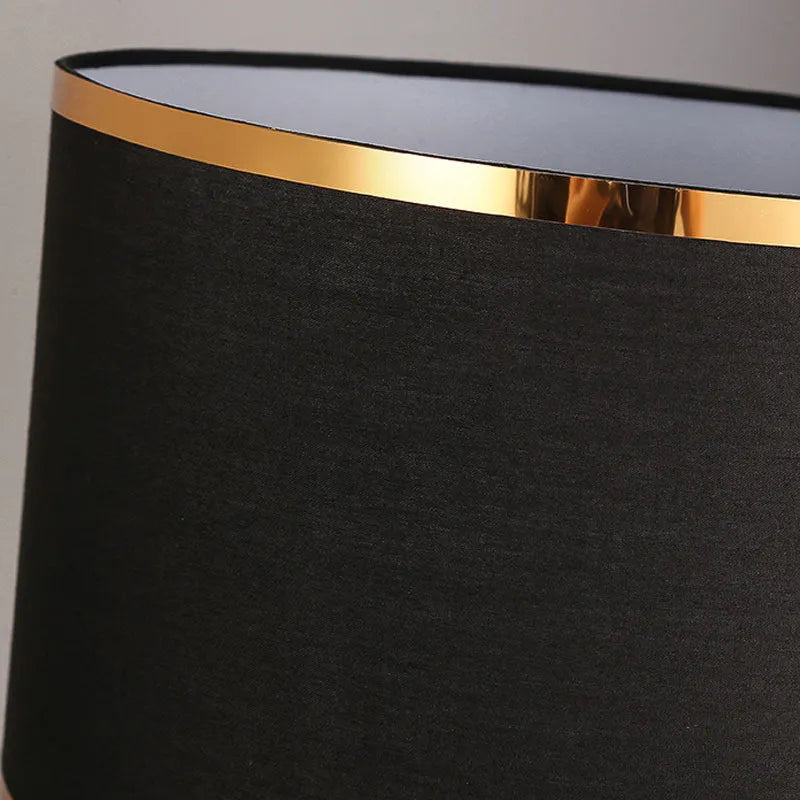 Black, gold, or white bedside table lamp with a fabric shade and iron base