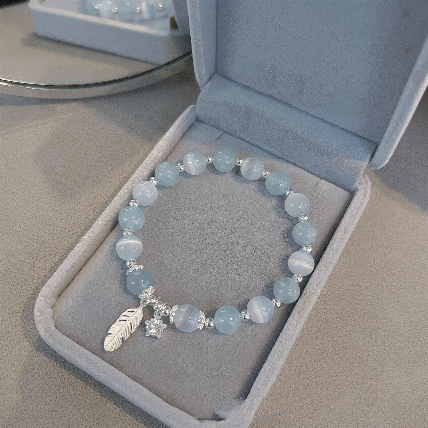 Small white crystal bracelet with eight star design in blue moonlight colour