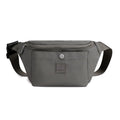 Women's nylon crossbody fanny pack in black with zippered compartments and letter detail.