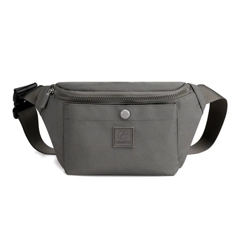 Women's nylon crossbody fanny pack in black with zippered compartments and letter detail.